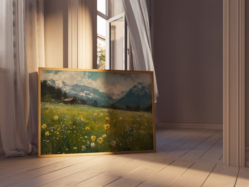May include: A framed landscape painting depicting a field of wildflowers with a small house in the distance and snow-capped mountains in the background.
