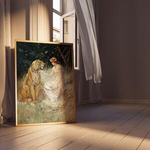 May include: A framed oil painting depicting a woman in a white dress sitting with a tiger in a forest setting. The woman is holding a flower in her hand and the tiger is looking at her.