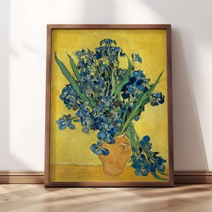 May include: A painting of a vase of blue irises against a yellow background. The irises are arranged in a loose bouquet and the vase is a simple, brown earthenware.