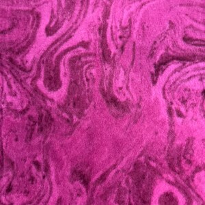May include: Close-up of a vibrant, textured fabric with a swirling pattern. The color is a deep magenta with darker, almost black, swirling veins throughout. The fabric appears soft and plush, with a velvety texture.