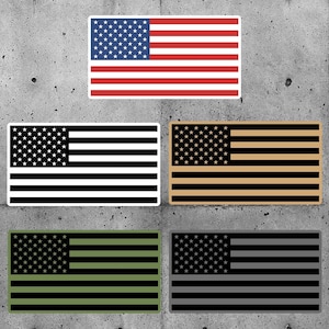 May include: Five different versions of the American flag. The first flag is the traditional red, white, and blue. The second flag is black and white. The third flag is black and tan. The fourth flag is black and green. The fifth flag is black and gray.
