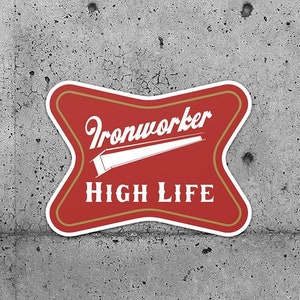 May include: Two red and gold star-shaped stickers with the text "Ironworker High Life" on a grey concrete background.