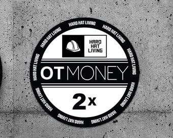 May include: Two black and white circular stickers with the text "HARD HAT LIVING" repeated around the edge. The center of each sticker features a hard hat icon, the text "HARD HAT LIVING", the text "OTMONEY", and the number "2x".