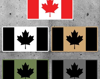 May include: Five different versions of the Canadian flag. The first flag is red and white with a red maple leaf. The other four flags are black and white with a black maple leaf. The background colours of the four flags are black, tan, green, and grey.