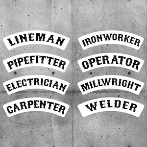 May include: Eight white arched stickers with black text on a grey concrete background. The stickers read: Lineman, Ironworker, Pipefitter, Operator, Electrician, Millwright, Carpenter, and Welder.