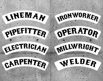 May include: Eight white arched stickers with black text on a gray concrete background. The stickers read: Lineman, Ironworker, Pipefitter, Operator, Electrician, Millwright, Carpenter, and Welder.