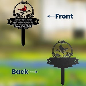 May include: Black metal memorial garden stake featuring a cardinal bird perched on a branch within a circular frame. The stake includes the text "Those we love don't go away... Emma Hale Smith 1936-2026". The back shows a silhouette of a bird.