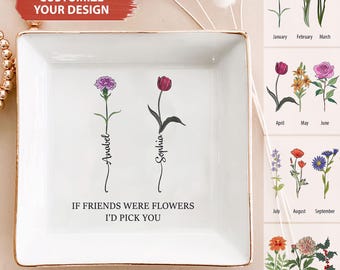 May include: White ceramic trinket tray with gold trim featuring two flowers with the names Anabel and Sophia written underneath. The text "If friends were flowers I'd pick you" is written below the flowers.