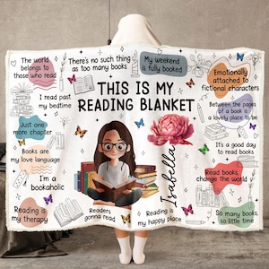 May include: A white fleece blanket featuring the text THIS IS MY READING BLANKET, a central illustration of a person reading a book, a large pink peony, the name Isabella, and various book-themed quotes and small colorful butterfly graphics.