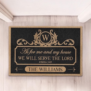 May include: Black doormat with a gold border and text. The text reads "As for me and my house WE WILL SERVE THE LORD JOSHUA 24:15 THE WILLIAMS". A gold "W" is at the top.