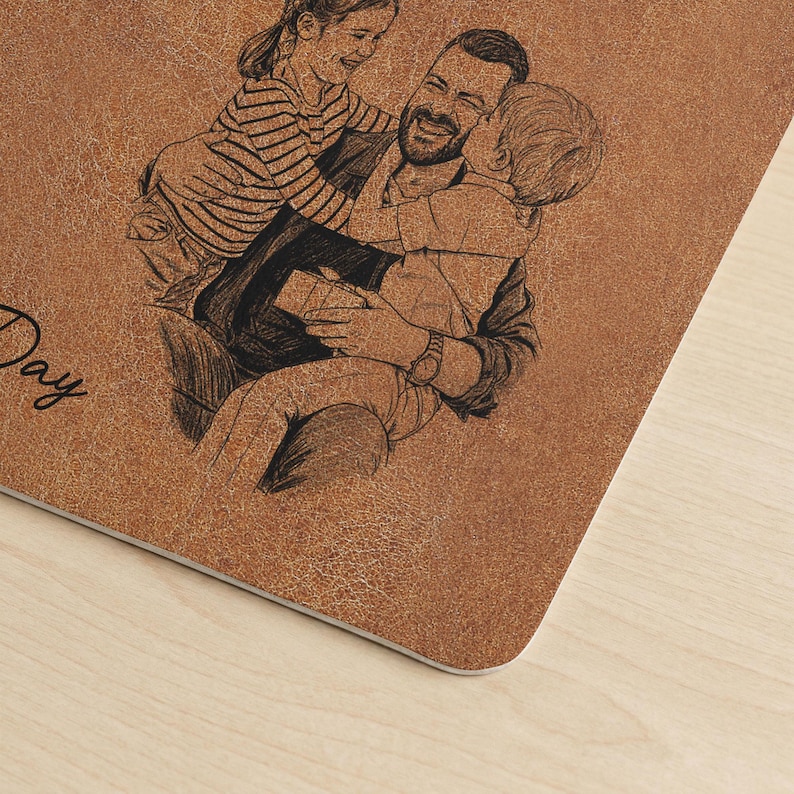 May include: A brown, textured, rectangular item with a sketch of a father and two children. The father is smiling and embracing the children. The word "Day" is visible in the image. The item appears to be a personalized gift.