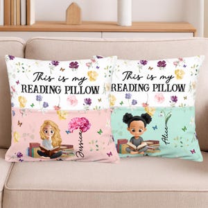 May include: Two rectangular reading pillows with floral and butterfly patterns. The top section of each pillow reads "This is my READING PILLOW". The bottom sections show illustrations of girls reading, with names "Jessica" and "Alice".