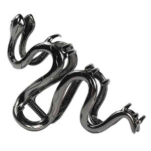May include: A dark gray metal hair clip in the shape of a snake. The clip features two snake heads at one end and a winding body with textured scales. The clip is designed to hold hair in place.