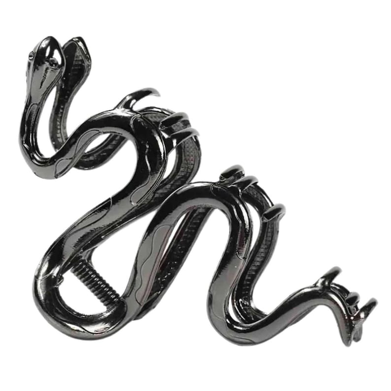 May include: A dark gray metal hair clip in the shape of a snake. The clip features two snake heads at one end and a winding body with textured scales. The clip is designed to hold hair in place.