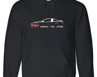 May include: Black hooded sweatshirt with a front pocket and a white car graphic. The text "DSM DIAMOND STAR MOTORS" is printed in white and red below the car graphic. The sweatshirt has a drawstring hood.