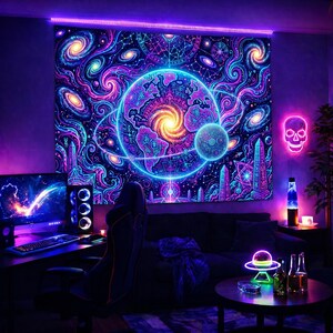 May include: A vibrant tapestry with a cosmic design featuring swirling galaxies, planets, and neon-colored celestial elements. The artwork is illuminated with purple and blue hues, creating a psychedelic atmosphere. A neon skull and a computer setup are also visible.