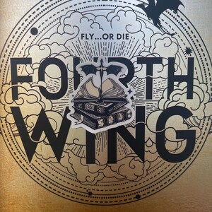 May include: A black and white book-themed sticker with a dragon and the words "Fly...or Die" and "Fourth Wing".