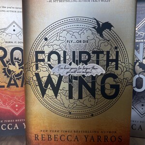 May include: Three fantasy novels with black and white illustrations of dragons and clouds. The titles are "Iron Flame", "Fourth Wing", and "Nyx & Ora". All three books are by the author Rebecca Yarros.