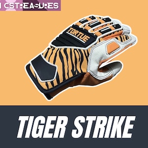 May include: A pair of orange and black tiger-print gloves with white accents and the word "Tortue" on the back of the hand. The gloves are designed for sports or training.
