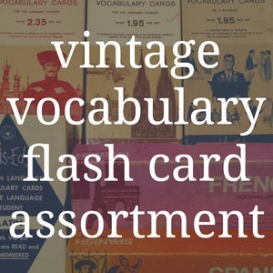 May include: Vintage vocabulary flash cards in a variety of languages, including Russian, German, English, French, Spanish, and Latin. The cards are in boxes with colorful illustrations and text. The boxes are arranged in a stack.