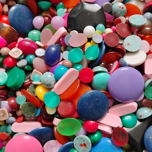 May include: A set of three ceramic mugs with a speckled, matte finish. The mugs are in shades of cream, light brown, and dark brown. Each mug has a simple, minimalist design and a rounded handle.