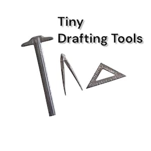 May include: A collection of miniature drafting tools, including a hammer, a compass, and a triangle ruler. The tools are made of a metallic material and are set against a white background. The text "Tiny Drafting Tools" is displayed above the tools.