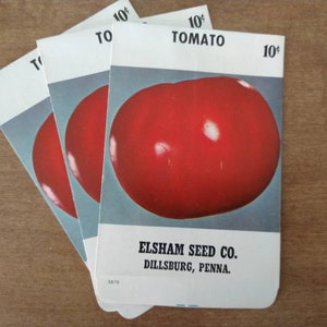 May include: Three vintage seed packets for tomato plants. Each packet features a red tomato illustration and the text "10¢ TOMATO" and "ELSHAM SEED CO. DILLSBURG, PENNA."