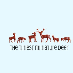May include: A collection of six miniature deer figurines in varying sizes and poses, all in a reddish-brown hue. The text "THE TINIEST MINIATURE DEER" is displayed below the figurines in a black, handwritten-style font. The background is a light blue.