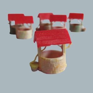 May include: Miniature well figurines with red roofs and beige brick-like walls. A small yellow bucket hangs from the side of the well. The wells are arranged on a light gray background.