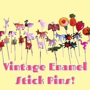 May include: A collection of vintage enamel stick pins featuring various animal, fruit, and holiday-themed designs. The pins are displayed on a yellow background with the text "Vintage Enamel Stick Pins!" in pink.