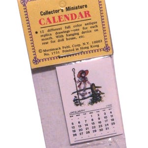 May include: A miniature calendar for dollhouses with a vintage illustration of a girl in a red hat and a white dress. The calendar is for January 1900 and is printed on a white card with a yellow border. The text on the card reads "Collector's Miniature Calendar 12 different full color antique replica drawings - one for each month. With hanging device on rear for doll house, etc. Merrimack Publ. Corp. N.Y. 10003 No. 1731 Printed in Hong Kong"