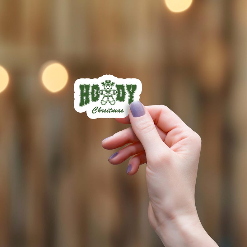 May include: Green and white sticker with the text "Ho! Ho! Ho!" and a gingerbread man wearing a cowboy hat. The text "Christmas" is below the gingerbread man.