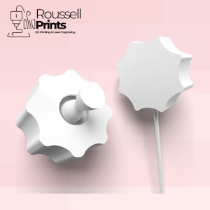 May include: Two white, star-shaped knobs, one with a cylindrical peg, and the other on a thin stem, are displayed against a soft pink background. The logo "Roussell Prints" is visible, indicating 3D printing and laser engraving services.