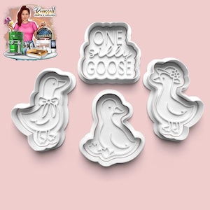 Può includere: Quattro formine per biscotti in plastica bianca a forma di oche e la scritta "ONE SILLY GOOSE". Un'oca ha un fiocco, un'altra un cappello. Le formine sono su sfondo rosa.