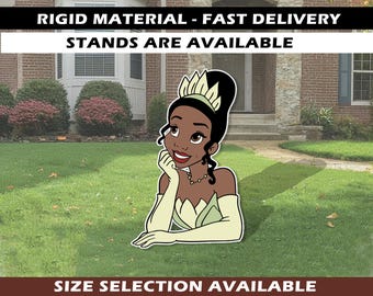 May include: A cut-out of a cartoon princess with black hair, a green dress, and a crown. The princess is smiling and resting her chin on her hand. The text "RIGID MATERIAL - FAST DELIVERY STANDS ARE AVAILABLE" is at the top. The text "SIZE SELECTION AVAILABLE" is at the bottom.