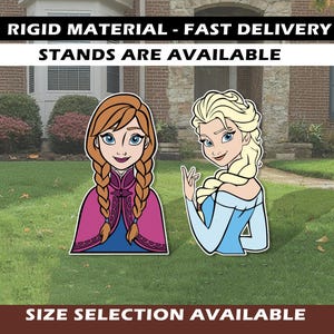 May include: Cutout figures of Anna and Elsa from the movie Frozen, standing on a lawn. Anna has red braids and a pink and blue outfit. Elsa has blonde hair and a blue dress. Text at the top says "RIGID MATERIAL - FAST DELIVERY STANDS ARE AVAILABLE".