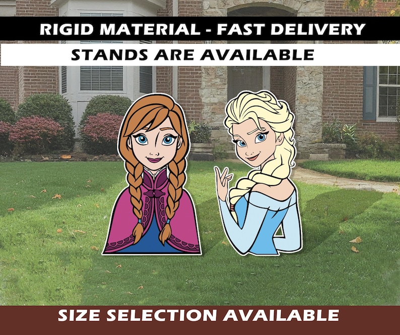 May include: Cutout figures of Anna and Elsa from the movie Frozen, standing on a lawn. Anna has red braids and a pink and blue outfit. Elsa has blonde hair and a blue dress. Text at the top says "RIGID MATERIAL - FAST DELIVERY STANDS ARE AVAILABLE".