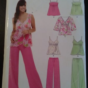 May include: A sewing pattern package featuring a woman in pink palazzo pants and a floral top. The package includes illustrations of various tops and pants. The brand name "NEW LOOK" is visible at the top, along with size information.