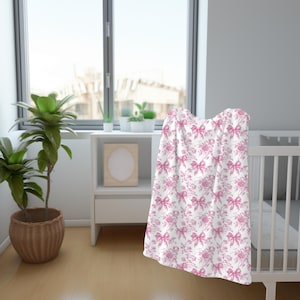 Soft throw blanket with shabby chic roses pattern on crib