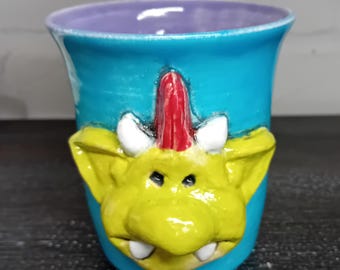 Ceramic Mug with Fungus the Bogeyman face on one side, Pale Blue and Orange.