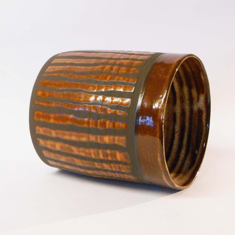 Wheel thrown black noir clay with Orange stripes.