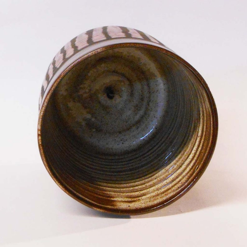 Wheel thrown black noir clay with Orange stripes.