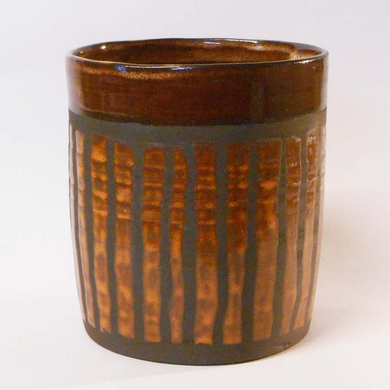 Wheel thrown black noir clay with Orange stripes.