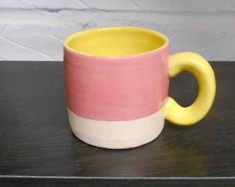 Ceramic Coffee Cup with Bright Yellow and Dark Pink glazes.