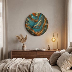 May include: A circular wall clock featuring a swirling abstract pattern of deep teal, copper, and brown tones. The clock face displays gold-colored Roman numerals at the twelve, three, six, and nine o'clock positions, with thin gold hands.