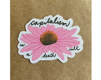 May include: A pink flower sticker with the text "Capitalism is a death cult" written in black.