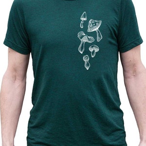 May include: A dark green t-shirt with a white outline of various mushrooms printed on the front.