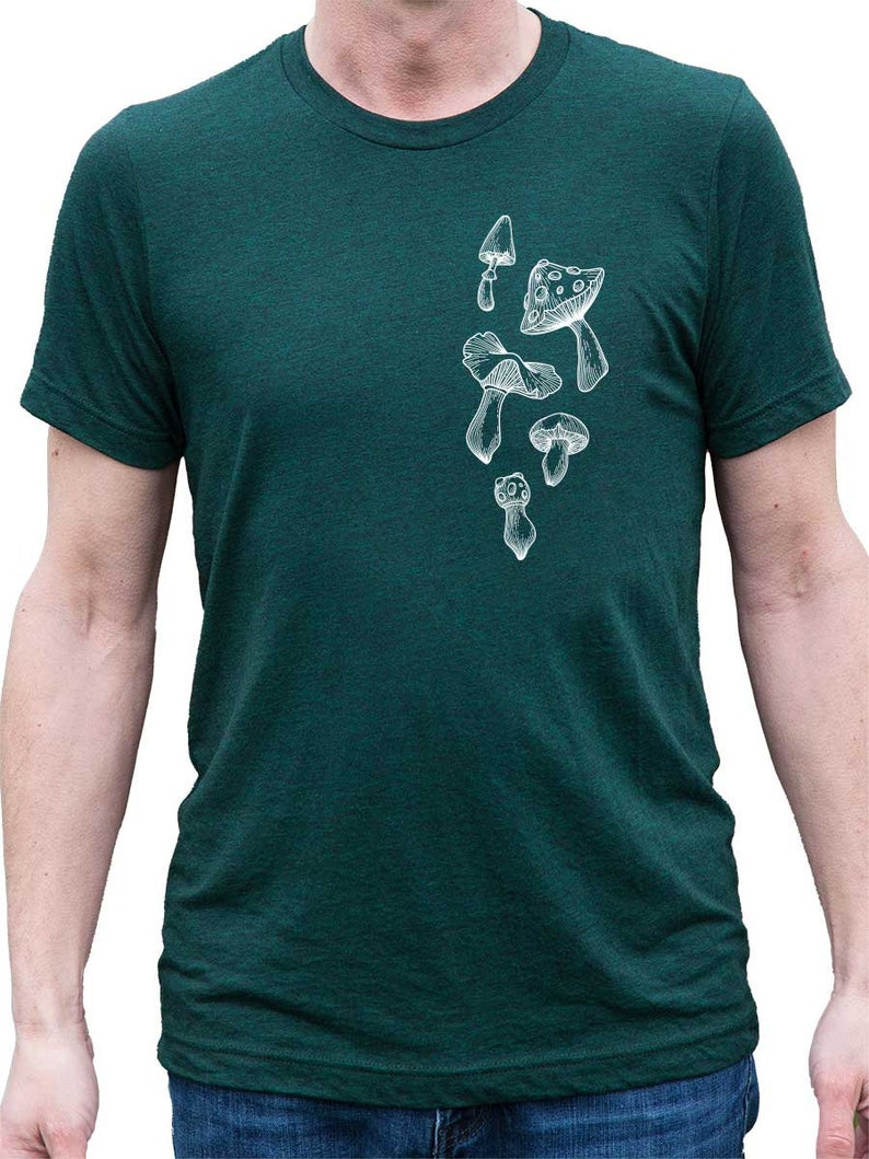 May include: A dark green t-shirt with a white outline of various mushrooms printed on the front.