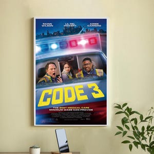 May include: A framed movie poster for "Code 3" featuring Rainn Wilson, Lil Rel Howery, and Aimee Carrero. The poster shows a scene inside an ambulance with the title in yellow block letters. The tagline reads: "THE BEST MEDICAL CARE MINIMUM WAGE CAN PROVIDE."