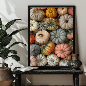 May include: A framed print featuring a close-up of a variety of pumpkins in shades of orange, yellow, green, blue, and white. The pumpkins are arranged in a random pattern, creating a visually appealing and autumnal design.